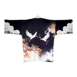 A black kimono-style top with a Japanese-inspired print featuring two white cranes, orange maple leaves, and white clouds, shown against a plain white background.